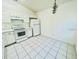 Bright kitchen featuring white appliances, cabinetry, and tile flooring at 3370 Cypress Point Cir, St Cloud, FL 34772