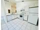 Bright kitchen featuring white appliances, cabinetry, dishwasher and tile flooring at 3370 Cypress Point Cir, St Cloud, FL 34772
