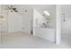 Open-concept living area with white tile floors, high ceilings, and bright lighting at 3370 Cypress Point Cir, St Cloud, FL 34772