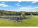 Community playground area features various play structures and a safety-approved surface at 3370 Cypress Point Cir, St Cloud, FL 34772