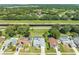 Aerial view showing the home's location near a canal and the surrounding neighborhood with pools at 3893 Blackberry Cir, St Cloud, FL 34769