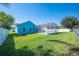 Expansive backyard featuring a screen-enclosed pool, lush lawn, privacy fence and mature trees at 3893 Blackberry Cir, St Cloud, FL 34769