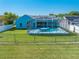 Home's outdoor space featuring a screened-in pool, lush grass, and privacy fencing at 3893 Blackberry Cir, St Cloud, FL 34769