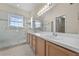 Ensuite bathroom featuring a double sink vanity, tiled floors, and a glass-enclosed shower at 3893 Blackberry Cir, St Cloud, FL 34769