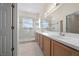 Ensuite bathroom with a double sink vanity, tiled floors, and a glass-enclosed shower at 3893 Blackberry Cir, St Cloud, FL 34769