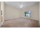 Spacious carpeted bedroom featuring a ceiling fan and a window providing natural light at 3893 Blackberry Cir, St Cloud, FL 34769