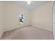 Neutral carpeted bedroom with ceiling fan and view to the outdoors at 3893 Blackberry Cir, St Cloud, FL 34769