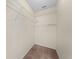 Walk-in closet with wire shelving and carpeted floor, providing ample storage space at 3893 Blackberry Cir, St Cloud, FL 34769