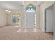 Inviting foyer featuring tile flooring, a bright entryway, and a partial view of the spacious living room at 3893 Blackberry Cir, St Cloud, FL 34769