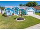 Charming blue single-story home with landscaped front yard and inviting curb appeal on a sunny day at 3893 Blackberry Cir, St Cloud, FL 34769