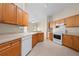Kitchen featuring wood cabinets, recessed lights, and white appliances at 3893 Blackberry Cir, St Cloud, FL 34769