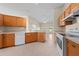 Bright kitchen with wood cabinets and view into adjacent living room at 3893 Blackberry Cir, St Cloud, FL 34769