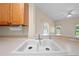Kitchen sink and counter with bar overlooking the living room and pool at 3893 Blackberry Cir, St Cloud, FL 34769