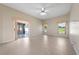 Living room featuring a fan, lots of natural light, and sliding doors to the outside at 3893 Blackberry Cir, St Cloud, FL 34769