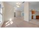 Bright open-concept living room with a decorative chandelier and neutral carpet at 3893 Blackberry Cir, St Cloud, FL 34769
