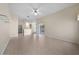 Open-concept living room with tile floors that leads to the kitchen and a dining area at 3893 Blackberry Cir, St Cloud, FL 34769