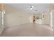 Open-concept living room featuring tile floors, neutral paint, and access to the kitchen at 3893 Blackberry Cir, St Cloud, FL 34769