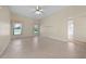 Large living room featuring tile flooring, two windows, and a ceiling fan at 3893 Blackberry Cir, St Cloud, FL 34769