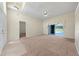 Open living space featuring carpet, tile entryway, and access to the home's screened-in pool at 3893 Blackberry Cir, St Cloud, FL 34769
