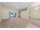 Large open living room with sliding glass doors to screened-in pool and neutral carpeting and wall paint at 3893 Blackberry Cir, St Cloud, FL 34769
