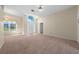 Spacious living room boasting plush carpeting, a large window with natural light, and neutral wall paint at 3893 Blackberry Cir, St Cloud, FL 34769