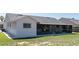 Exterior view of the backyard featuring a screen enclosed lanai, window with bars, and easy yard maintenance at 408 Sandpiper Ridge Dr, Orlando, FL 32835
