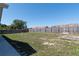 Large, grassy backyard with a wooden fence, offering ample space for outdoor activities and privacy at 408 Sandpiper Ridge Dr, Orlando, FL 32835