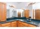 Large bathroom featuring double sinks with green countertops and wood cabinets at 408 Sandpiper Ridge Dr, Orlando, FL 32835