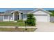 Charming single-story home with a well-maintained front yard, lush landscaping, and attached two-car garage at 408 Sandpiper Ridge Dr, Orlando, FL 32835