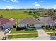 Aerial view of a single-Gathering home with well-manicured lawn and landscaping backing to a golf course at 426 Prestwick Dr, Davenport, FL 33897