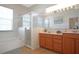 Bright bathroom with a double sink vanity, glass shower, and a soaking tub at 426 Prestwick Dr, Davenport, FL 33897