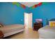 Cozy bedroom featuring two twin beds, neutral decor, and a mounted television at 426 Prestwick Dr, Davenport, FL 33897