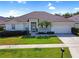 Charming single-story home featuring manicured lawn, attached two-car garage, and lovely landscaping in a desirable location at 426 Prestwick Dr, Davenport, FL 33897