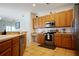Well-equipped kitchen featuring stainless steel appliances, tile floors, and ample cabinet space, ready for any meal at 426 Prestwick Dr, Davenport, FL 33897