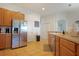 Bright kitchen with stainless steel refrigerator, plenty of cabinet space, tile floors, and access to other rooms at 426 Prestwick Dr, Davenport, FL 33897