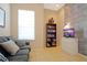 Cozy living room with comfortable seating, shelving, and a TV for entertainment at 426 Prestwick Dr, Davenport, FL 33897