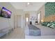 Spacious main bedroom with tropical decor, large bed, and mounted TV for relaxing evenings at 426 Prestwick Dr, Davenport, FL 33897