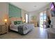Comfortable main bedroom featuring tropical decor and access to an outdoor pool area at 426 Prestwick Dr, Davenport, FL 33897