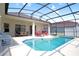 Inviting screened-in pool with multiple lounge chairs and an outdoor dining table at 426 Prestwick Dr, Davenport, FL 33897