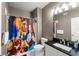 This fun bathroom features a shower/tub with a vibrant Beauty and the Beast shower curtain, complemented by dark countertops at 438 Water St # 438, Celebration, FL 34747