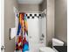 An efficient bathroom featuring a shower/tub, tiled backsplash, and coordinating towels and curtain, ensuring functionality and style at 438 Water St # 438, Celebration, FL 34747