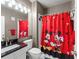 Cute bathroom with Mickey Mouse themed shower curtain, vanity, mirror, and toilet at 438 Water St # 438, Celebration, FL 34747