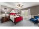 This cozy bedroom features neutral walls, plush carpet, and a striking red bed frame, creating an inviting and stylish retreat at 438 Water St # 438, Celebration, FL 34747