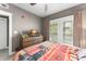 A comfy bedroom offers natural light, ceiling fan, shuttered windows, and a charming wood dresser at 438 Water St # 438, Celebration, FL 34747