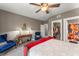 Charming bedroom featuring a unique red bed, cozy sitting area, and convenient access to closet and bathroom at 438 Water St # 438, Celebration, FL 34747