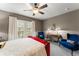 This warm bedroom is complete with neutral walls, a vibrant red bed frame, elegant decor, and inviting window views at 438 Water St # 438, Celebration, FL 34747