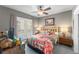 Cozy bedroom with a ceiling fan, wooden furniture, grey walls and bright colorful bedding at 438 Water St # 438, Celebration, FL 34747