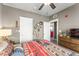 This bedroom includes a ceiling fan, dresser with a TV, and decoratively hung wall art at 438 Water St # 438, Celebration, FL 34747