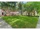 A sweeping green lawn, framed by mature trees and well-maintained buildings, invites residents to enjoy outdoor activities at 438 Water St # 438, Celebration, FL 34747