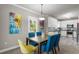 Dining room with wood table and stylish chairs, open to the modern kitchen at 438 Water St # 438, Celebration, FL 34747